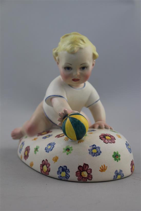 A Lenci pottery figure of a baby playing with a ball, 1930s, 17.5cm